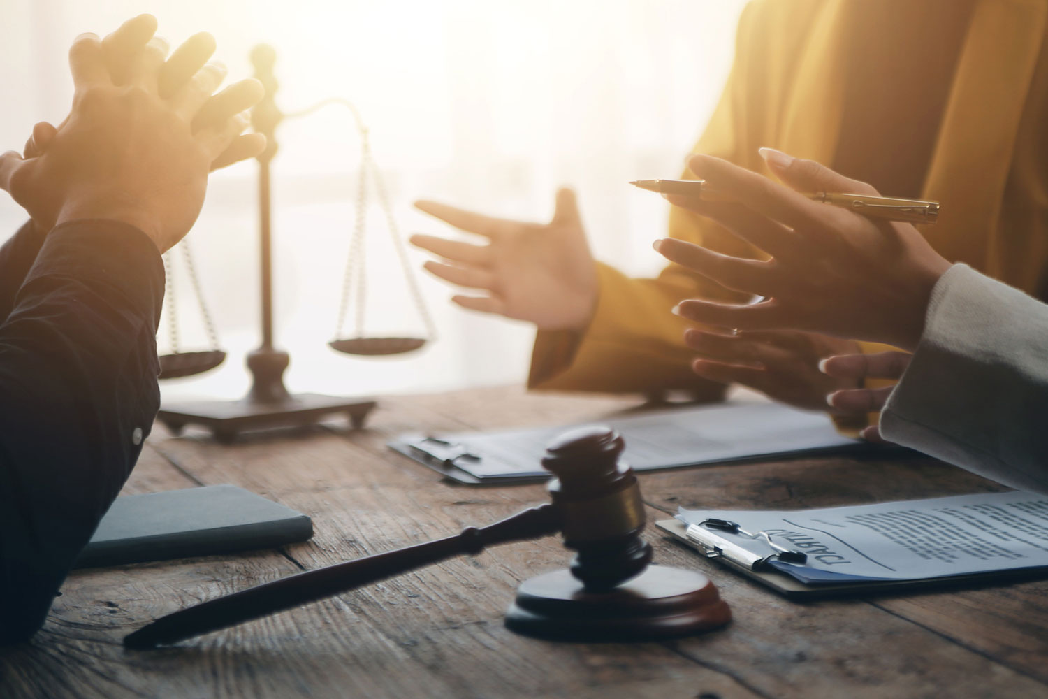 Lawyers reviewing documents and discussing a California personal injury claim settlement